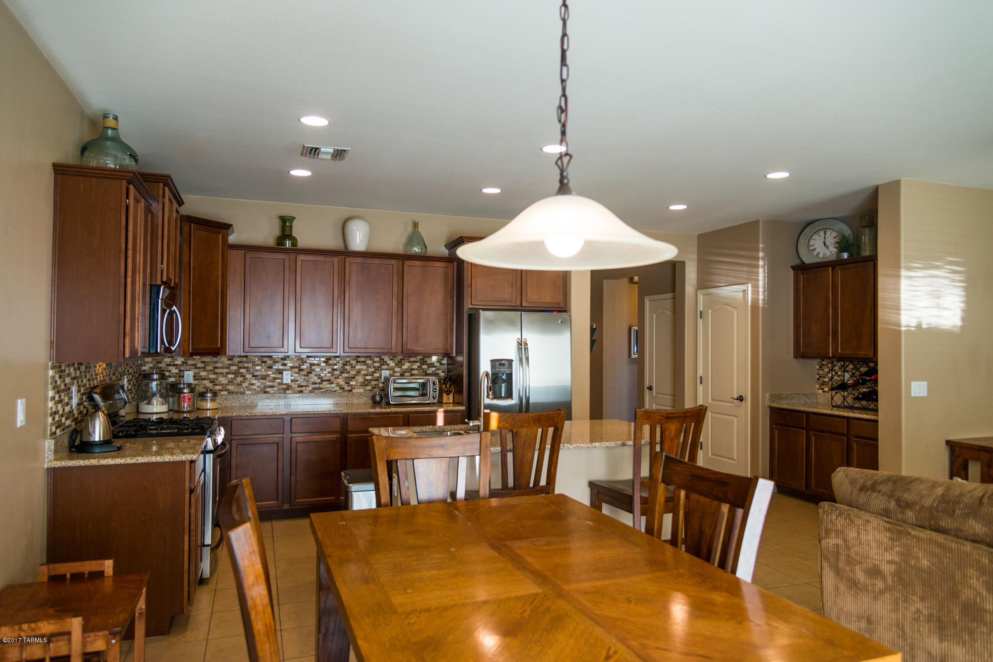 4405 West Crystal Ranch Place Marana, AZ 85658 - Photo 8 of 44 a kitchen with a table and chairs in it