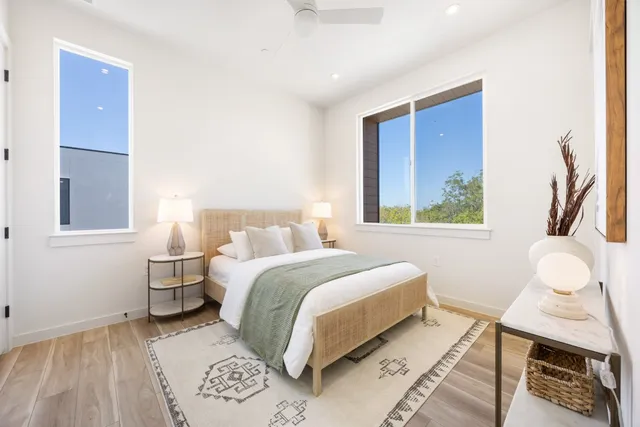 a bedroom with a bed and wooden floor