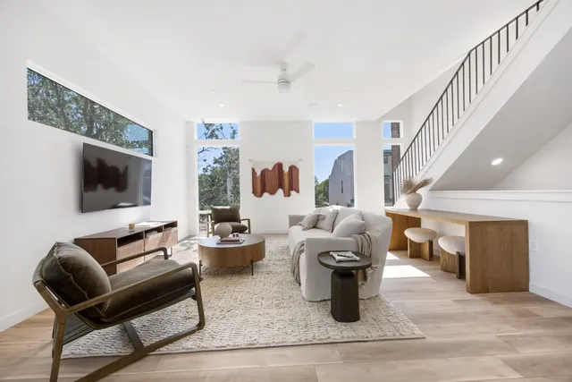 a living room with patio furniture and a flat screen tv