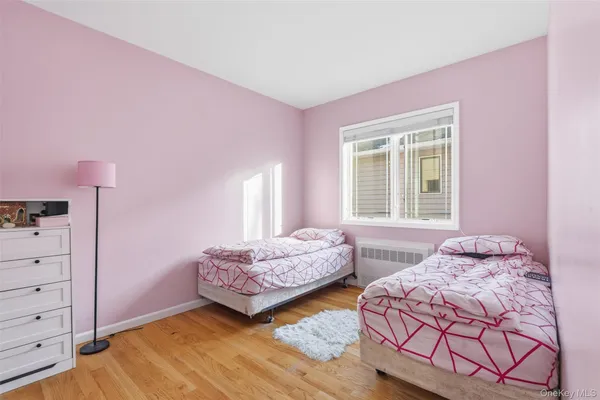 a bedroom with two beds and window