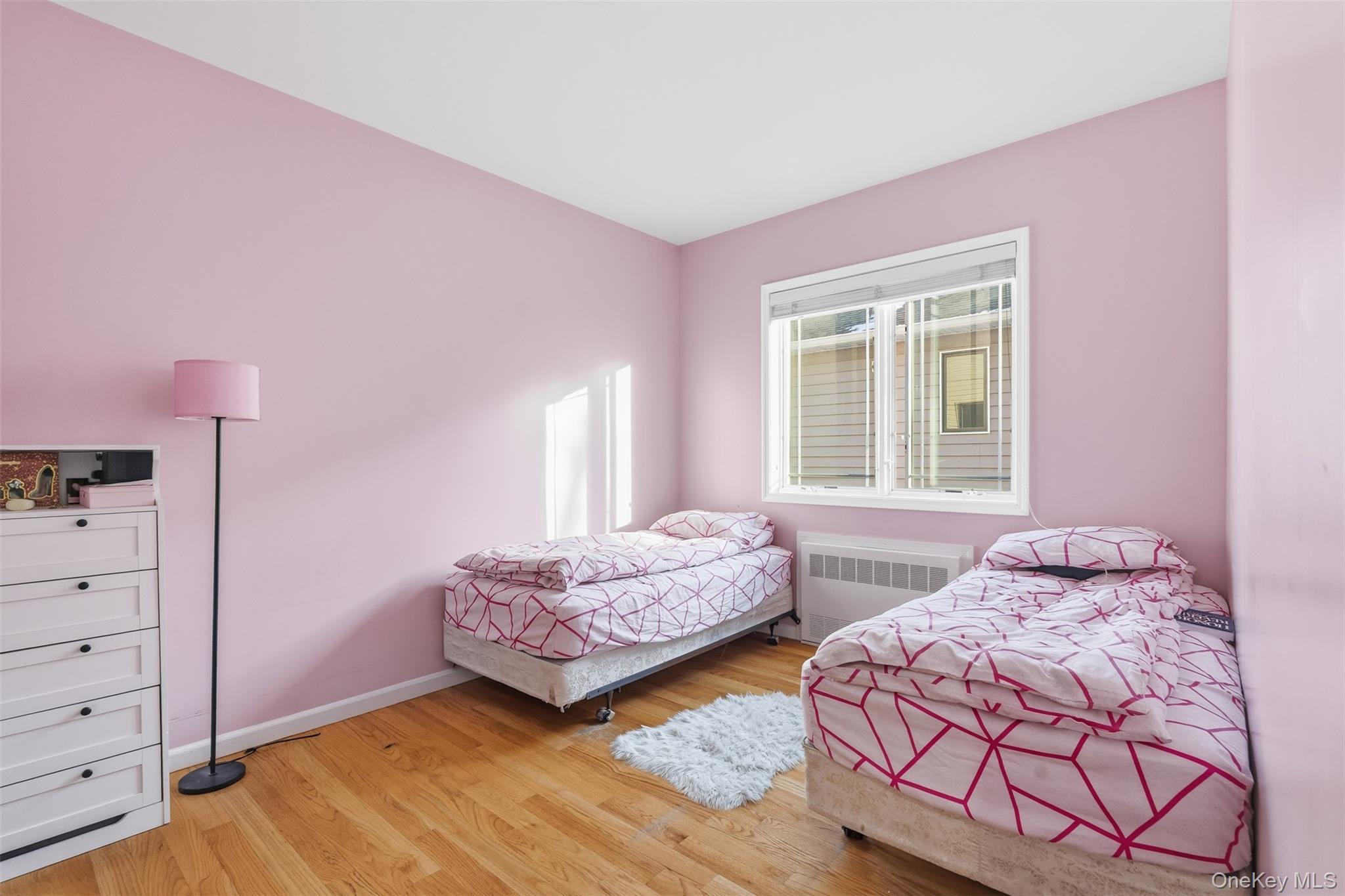 7 Park Street, Unit 301 Spring Valley, NY 10977 - Photo 18 of 33 a bedroom with two beds and window