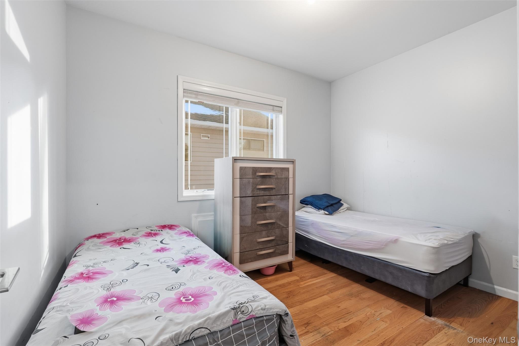 7 Park Street, Unit 301 Spring Valley, NY 10977 - Photo 20 of 33 a bedroom with a bed and a window