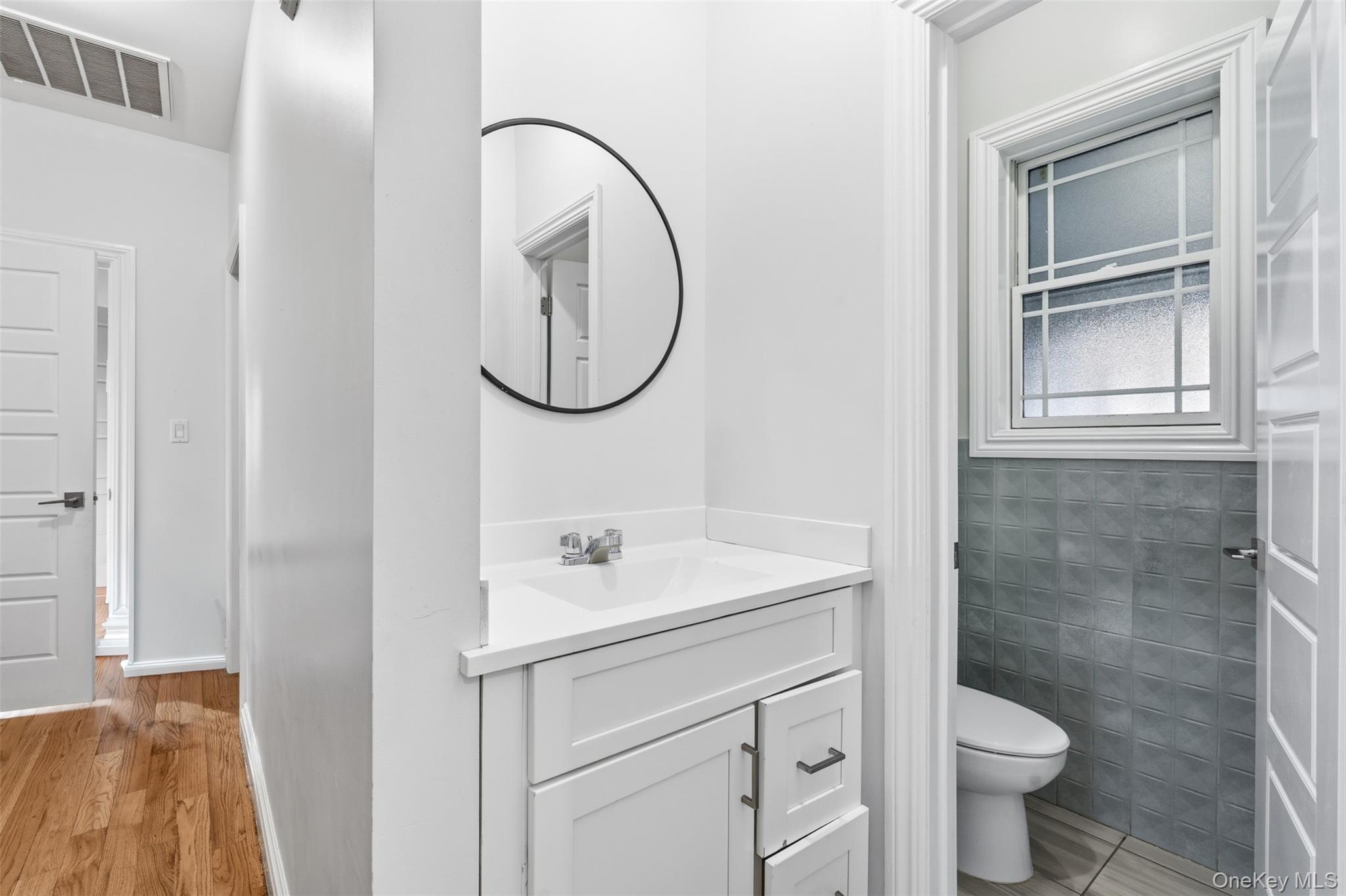 7 Park Street, Unit 301 Spring Valley, NY 10977 - Photo 21 of 33 a bathroom with a sink toilet and a mirror