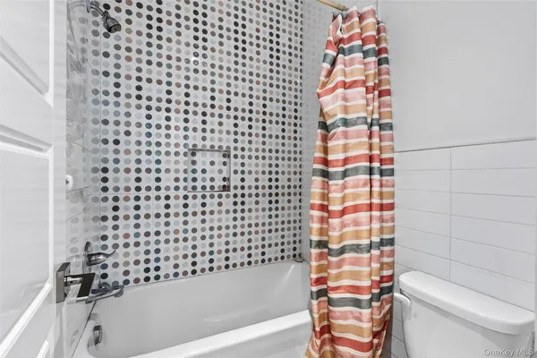 a bathroom with a bathtub and a toilet