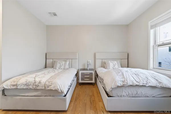 a bedroom with two beds and a night stand