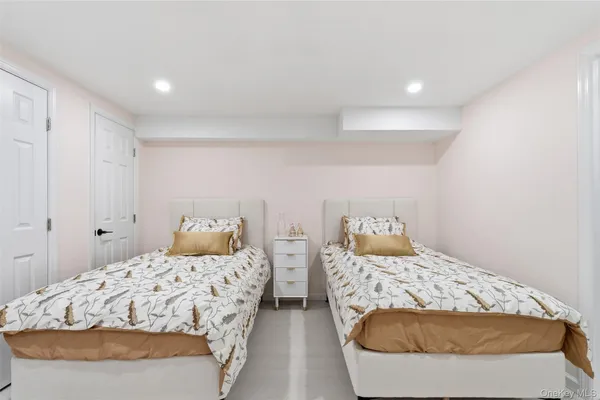 a bedroom with two beds and painted walls