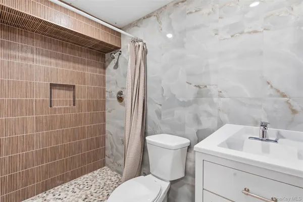 a bathroom with a sink toilet and shower