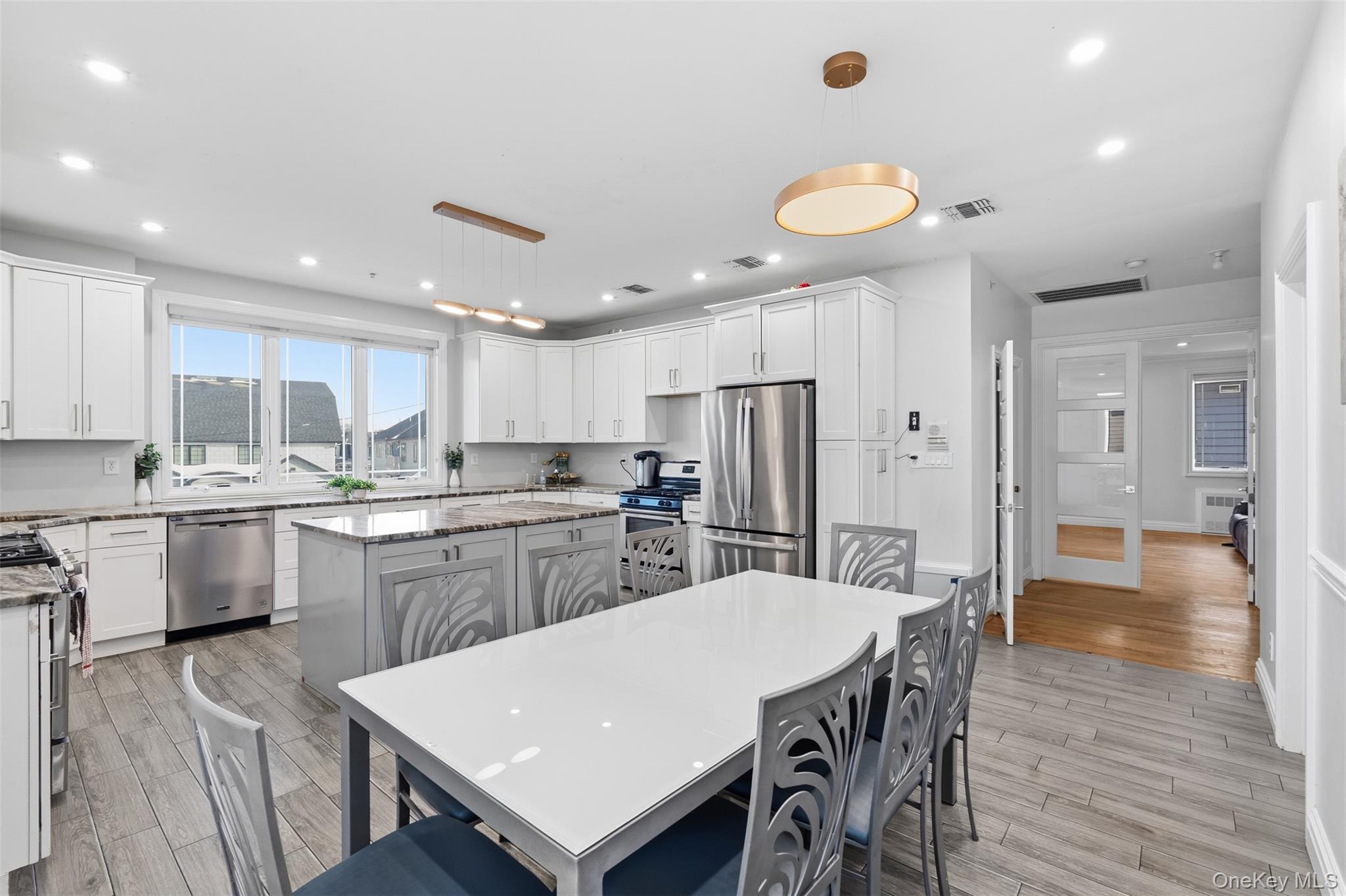 7 Park Street, Unit 301 Spring Valley, NY 10977 - Photo 5 of 33 a kitchen with stainless steel appliances granite countertop a kitchen island a stove a table and a refrigerator