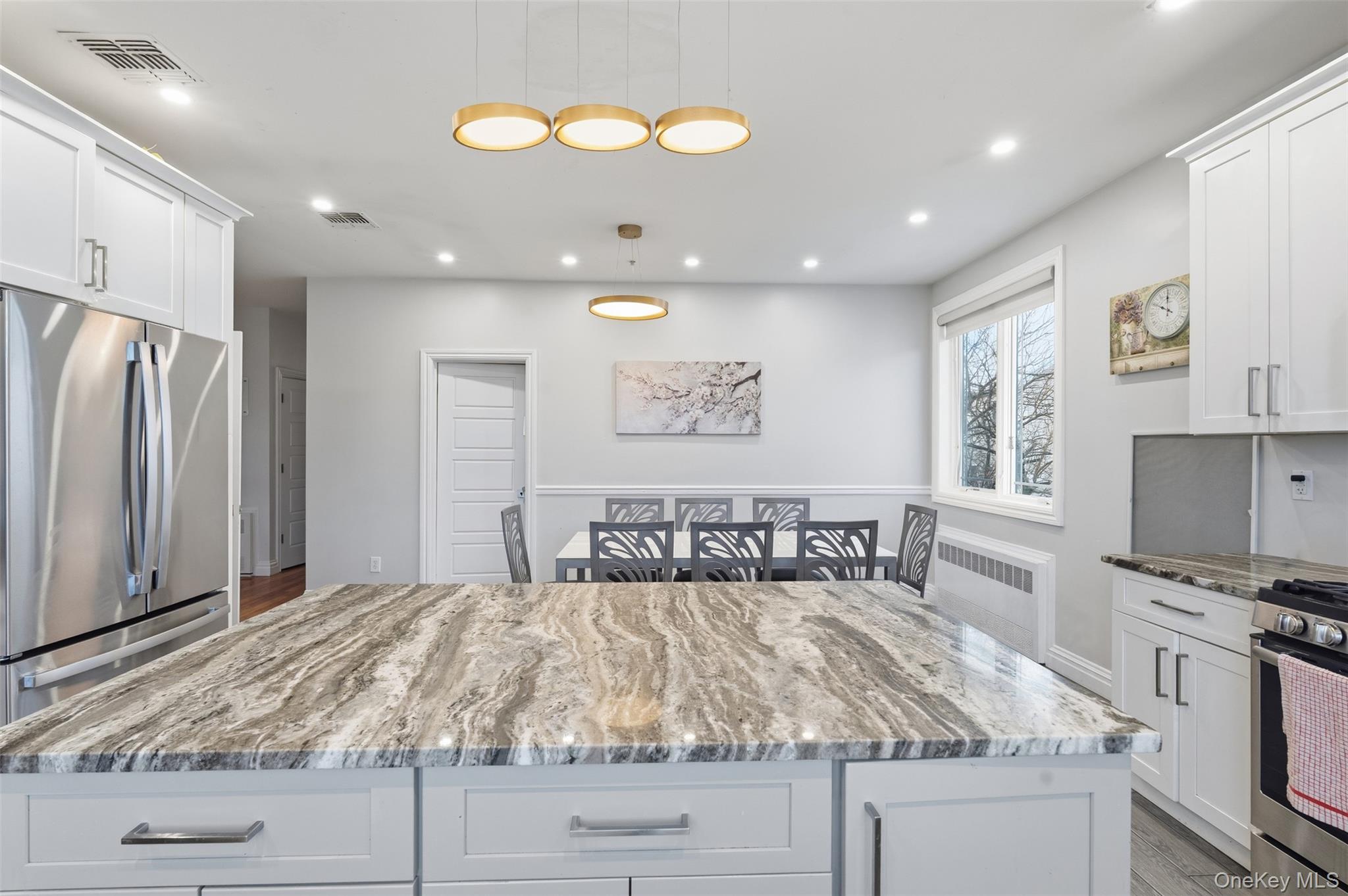 7 Park Street, Unit 301 Spring Valley, NY 10977 - Photo 6 of 33 a kitchen with kitchen island granite countertop a stove cabinets and refrigerator
