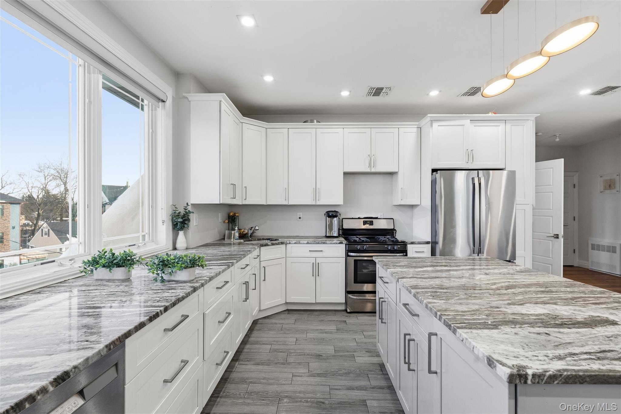 7 Park Street, Unit 301 Spring Valley, NY 10977 - Photo 8 of 33 a large kitchen with stainless steel appliances granite countertop a stove a sink and a refrigerator