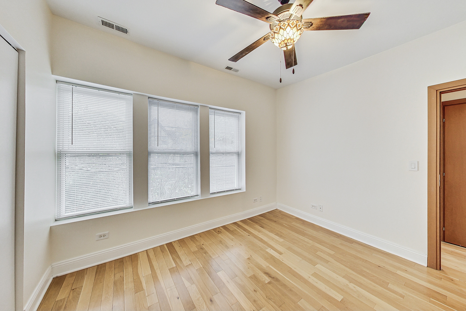 7321 North Paulina Street, Unit 2 Chicago, IL 60626 - Photo 12 of 27 an empty room with a window and a ceiling fan