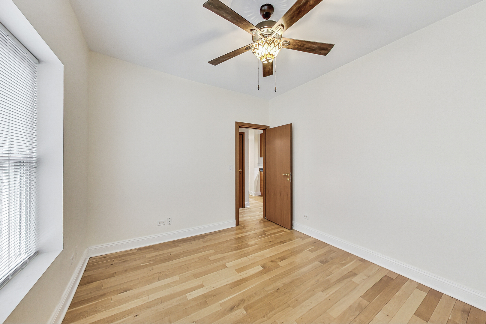 7321 North Paulina Street, Unit 2 Chicago, IL 60626 - Photo 13 of 27 an empty room with a window and a ceiling fan