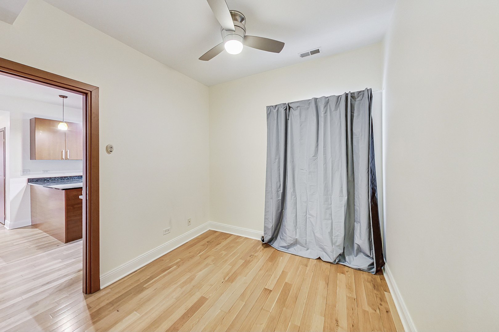7321 North Paulina Street, Unit 2 Chicago, IL 60626 - Photo 16 of 27 wooden floor in an empty room with a window