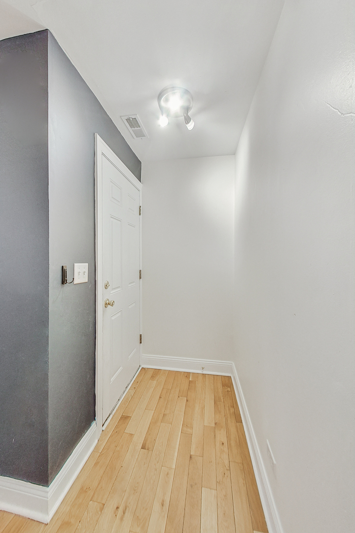 7321 North Paulina Street, Unit 2 Chicago, IL 60626 - Photo 3 of 27 a view of a room with wooden floor and bathroom