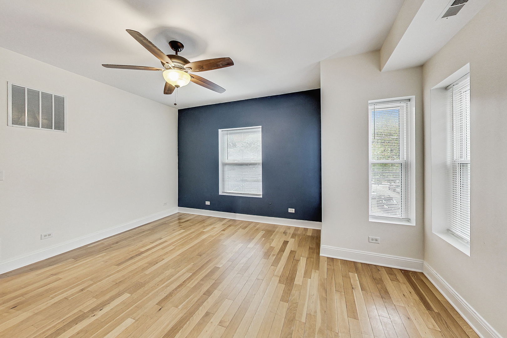 7321 North Paulina Street, Unit 2 Chicago, IL 60626 - Photo 5 of 27 a view of empty room with wooden floor and fan