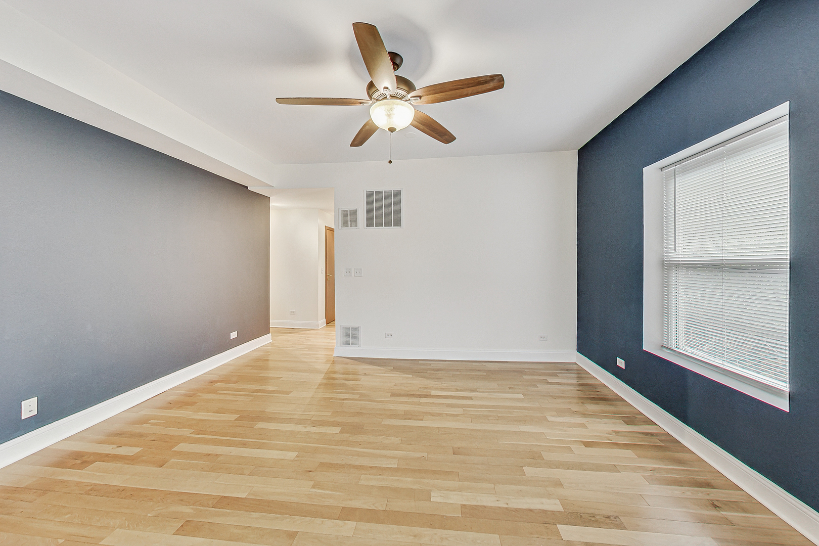 7321 North Paulina Street, Unit 2 Chicago, IL 60626 - Photo 6 of 27 a view of an empty room with window and wooden floor