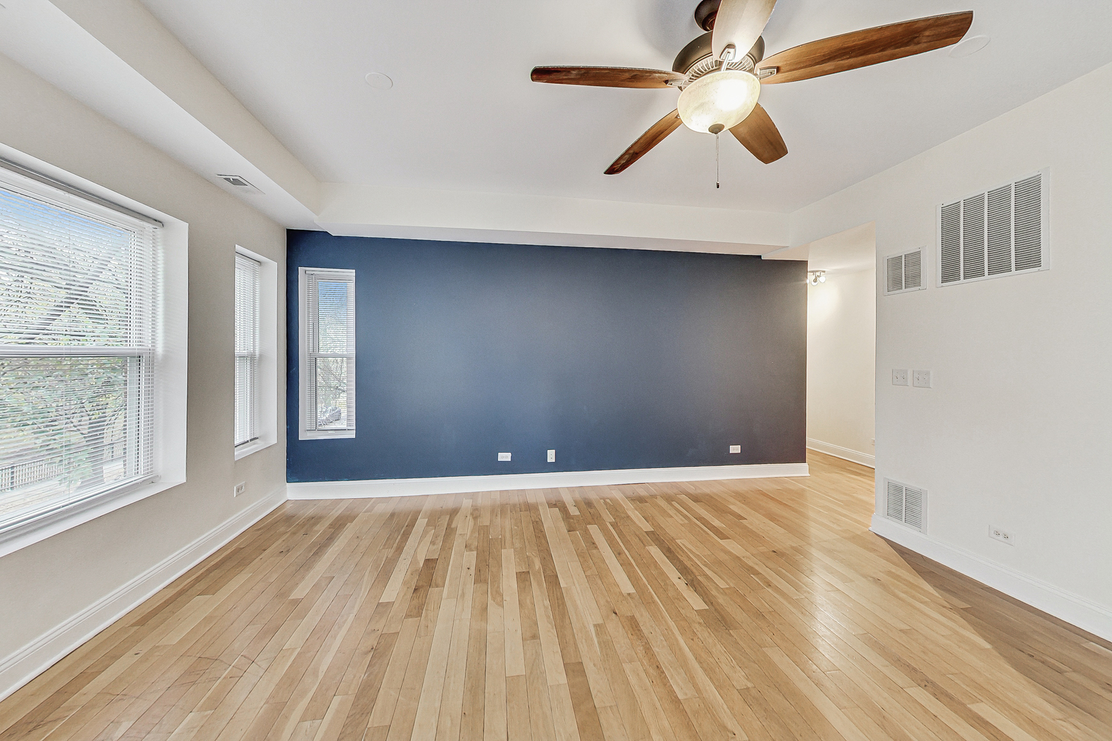 7321 North Paulina Street, Unit 2 Chicago, IL 60626 - Photo 7 of 27 a view of an empty room with window and wooden floor