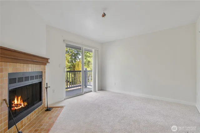 a view of an empty room with a fireplace