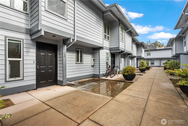 a view of a patio with table and chairs and potted plants