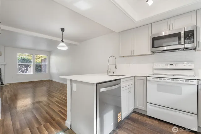 a kitchen with a sink appliances and cabinets