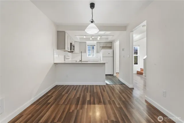 a view of a room with wooden floor and large windows