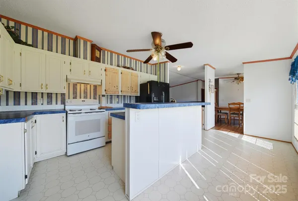 a kitchen view with cabinets and white appliances