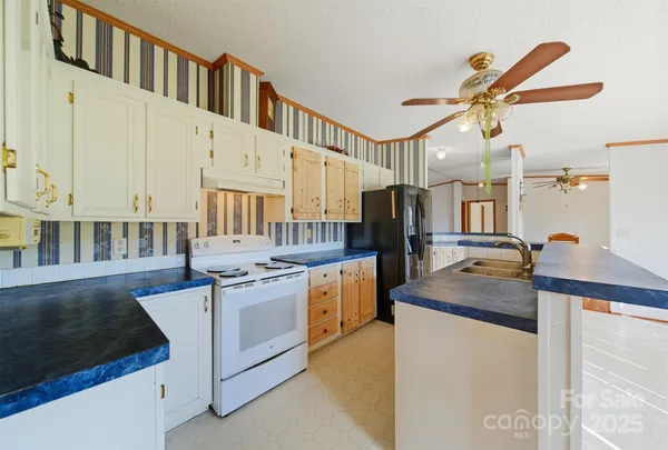 a kitchen with stainless steel appliances granite countertop a sink and stove