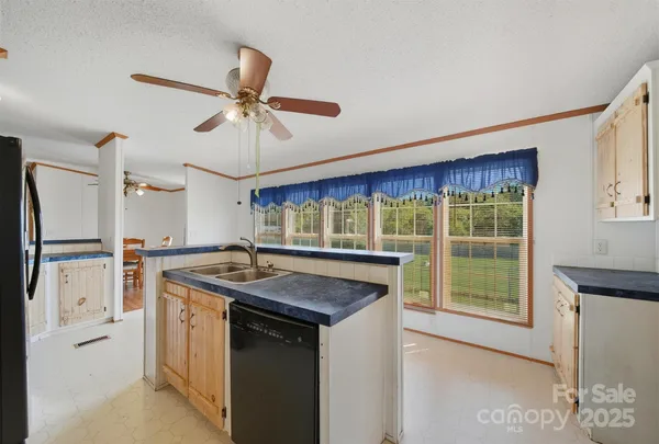 a kitchen with stainless steel appliances granite countertop a sink and a refrigerator
