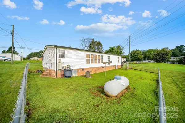 a view of a backyard with swimming pool