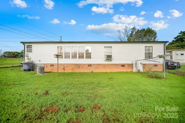 a view of a house with backyard sitting area and garden