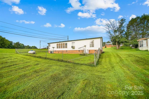 a swimming pool with outdoor seating and yard