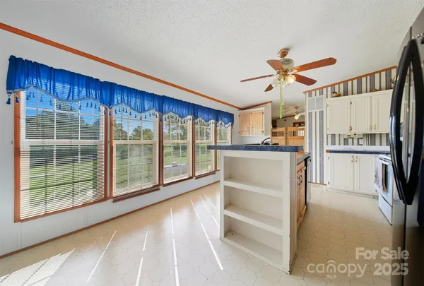 a view of kitchen with furniture and refrigerator