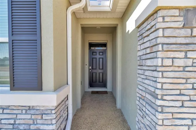 an empty room with a ceiling fan and a rug