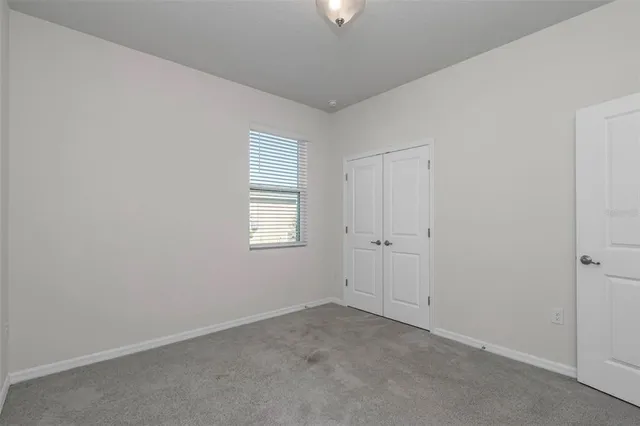 an aerial view of a swimming pool with a yard