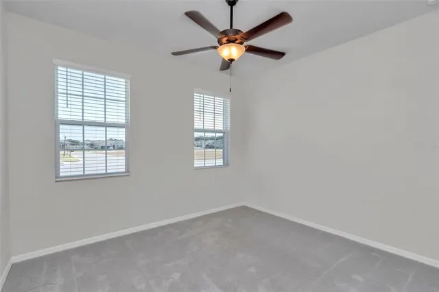 a aerial view of a house with a yard table and chairs