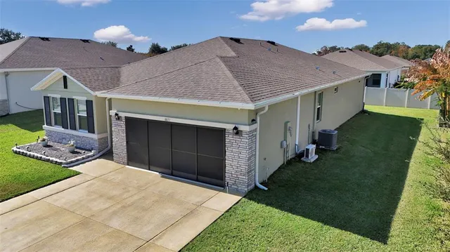 a aerial view of a house with a yard and garage