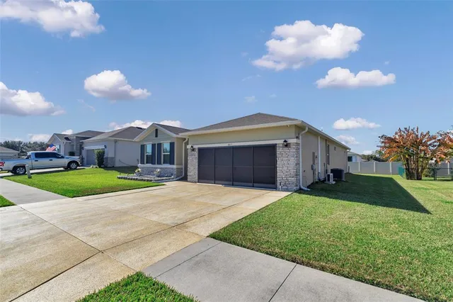 an aerial view of multiple houses with a yard