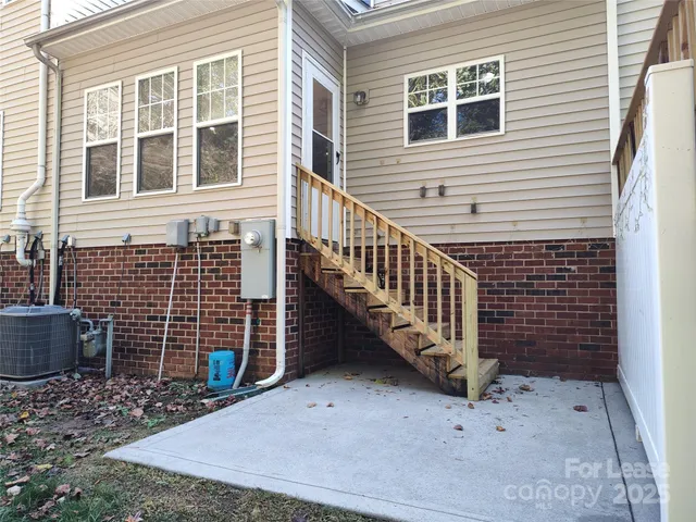 a view of a house with wooden fence