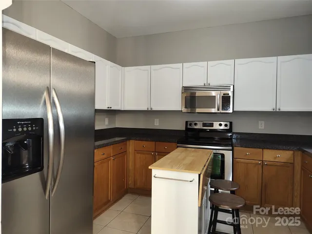 a kitchen with cabinets and stainless steel appliances