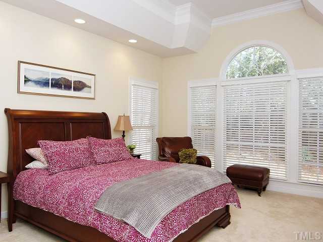 8604 Wapello Lane Raleigh, NC 27613 - Photo 14 of 25 Retreat to the hushed, ample master bedroom with deep tray ceiling and 2" blinds.