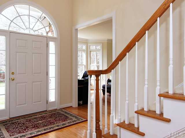 8604 Wapello Lane Raleigh, NC 27613 - Photo 2 of 25 Genteel entry with fanlight and sidelight windows to two-story foyer with large dramatic chandelier.