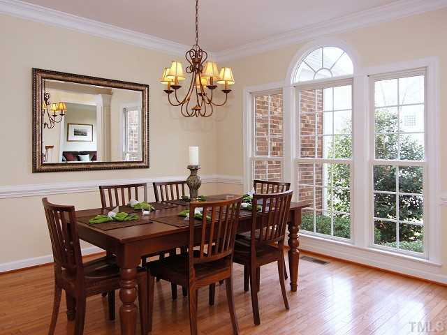 8604 Wapello Lane Raleigh, NC 27613 - Photo 4 of 25 Formal dining with chair molding and elegant chandelier.