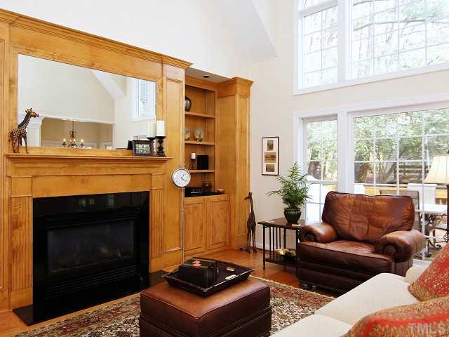 8604 Wapello Lane Raleigh, NC 27613 - Photo 5 of 25 Light, bright, and uplifting family room with warm oak built-ins and mantle around a clean and efficient gas fireplace.
