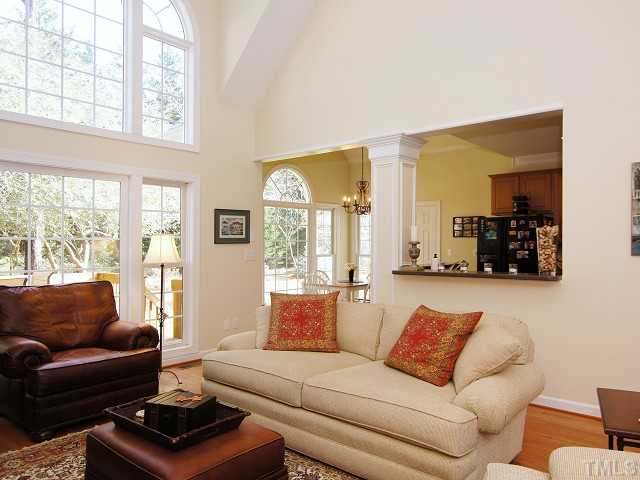 8604 Wapello Lane Raleigh, NC 27613 - Photo 6 of 25 Resplendent two-story windows fill the family room with daylong ancillary light.