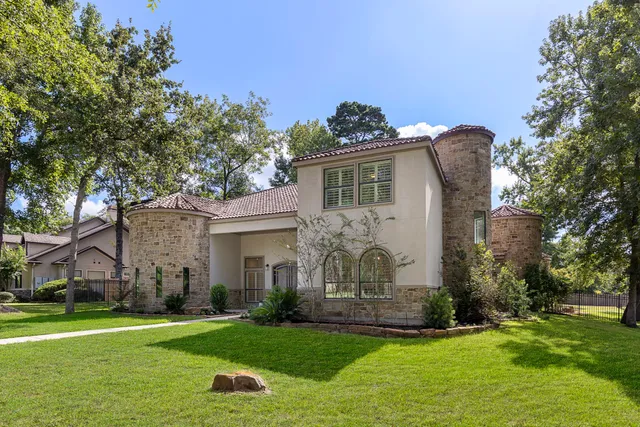 a front view of a house with a garden and plants