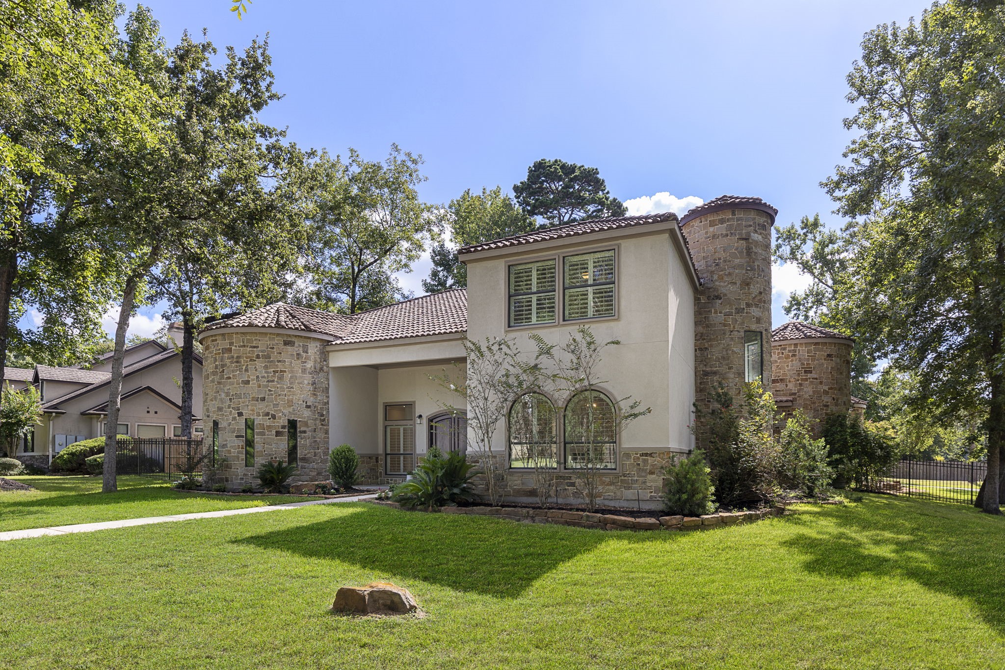 a front view of a house with a garden and plants