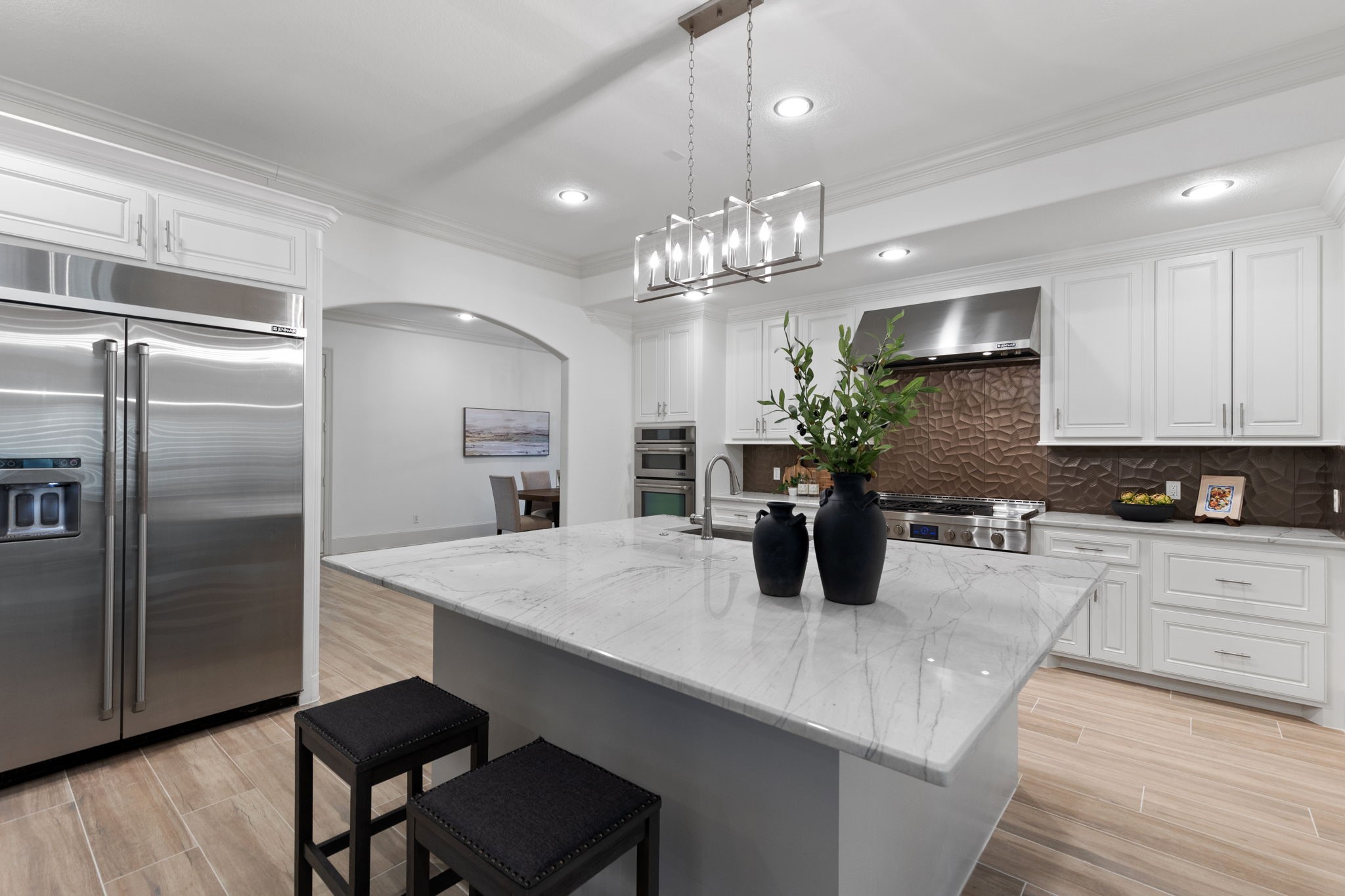 27502 Whispering Maple Way Spring, TX 77386 - Photo 12 of 46 Recently expanded, this impressive Chef's Kitchen showcases a built-in JennAir refrigerator and premium JennAir cooking appliances, including a gas range with 6-burner cooktop, griddle, and double oven. With a built-in wall oven, this is truly a 3-oven kitchen designed for serious cooking and entertaining!