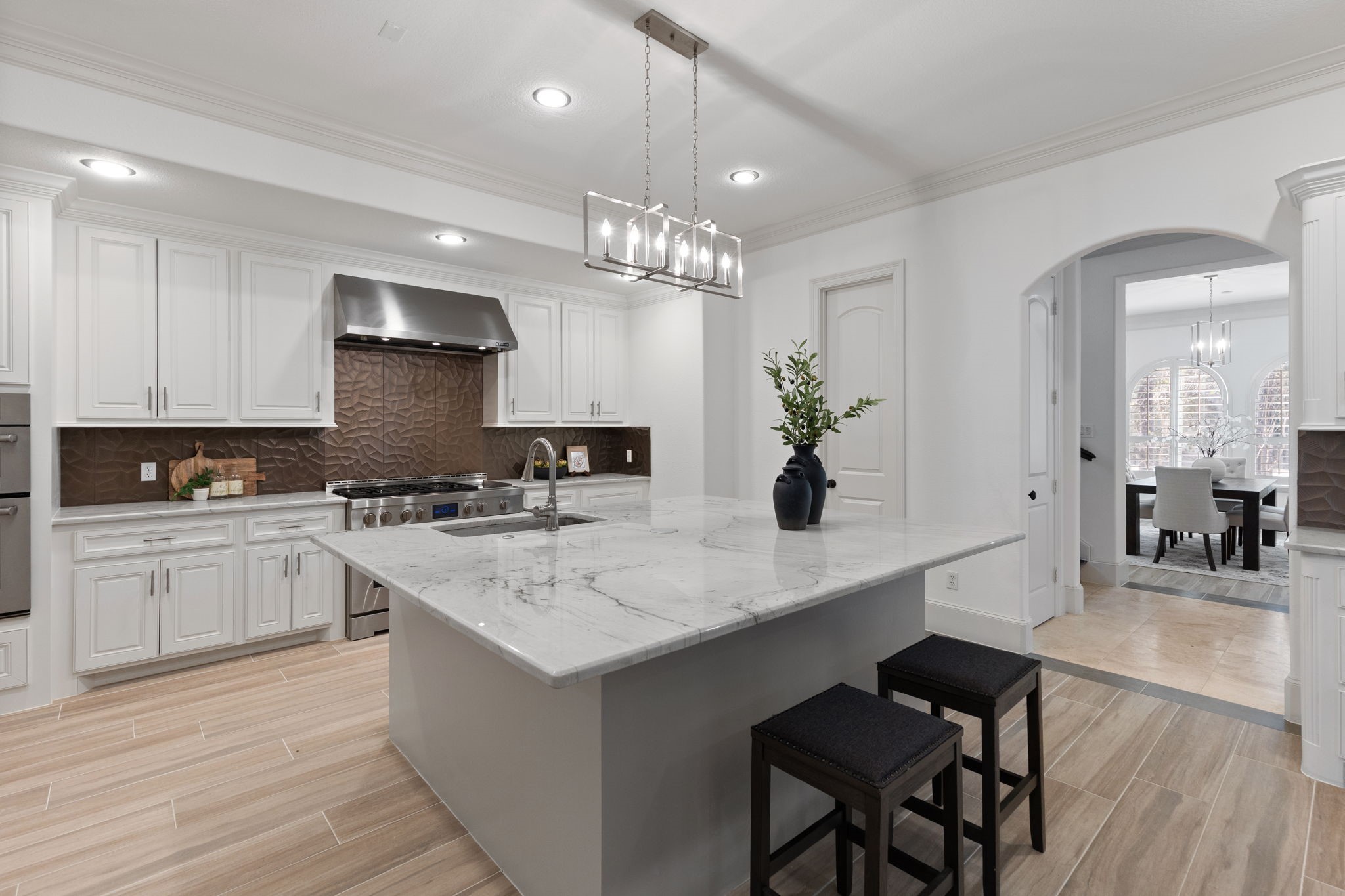 27502 Whispering Maple Way Spring, TX 77386 - Photo 13 of 46 The Kitchen also boasts crown molding, a spacious walk-in pantry, and recently installed wood-look tile plank flooring with updated cabinetry hardware