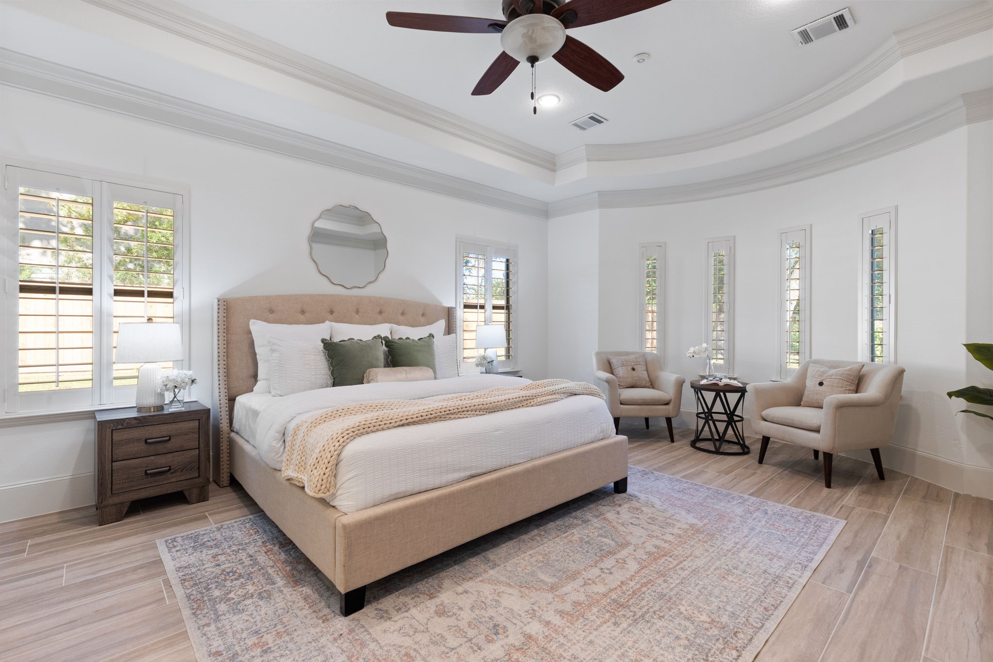 27502 Whispering Maple Way Spring, TX 77386 - Photo 18 of 46 Expansive 20x15 Primary Retreat with updated wood-look tile flooring, tray ceiling with crown molding, and bay windows with plantation shutters. The suite includes expanded walk-in closets with custom built-ins, dressers, and shoe storage!