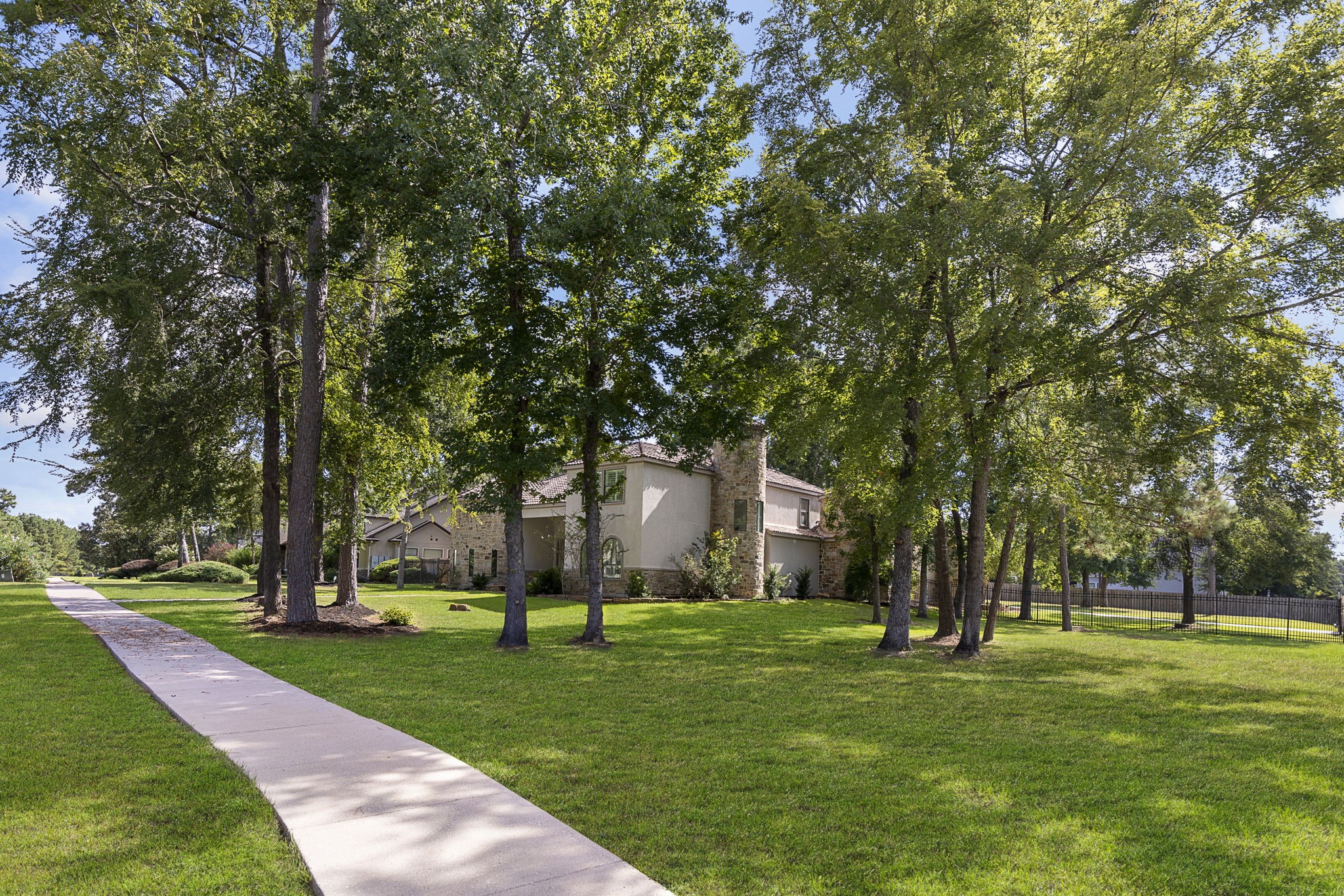 27502 Whispering Maple Way Spring, TX 77386 - Photo 2 of 46 Set on a gorgeous 1.2-acre corner lot surrounded by mature trees, offering privacy and curb appeal.